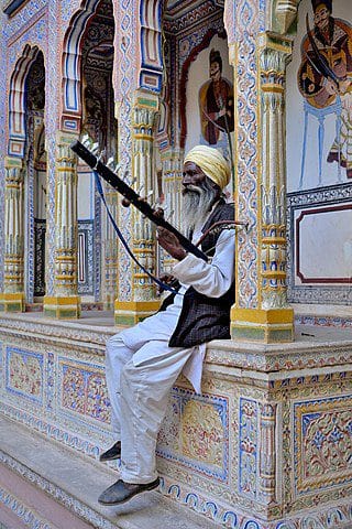 A local Shekhavati plays an instrument in Dr. Ramnath Podar Haveli Museum - one of the HistoricHavelis in India. Image courtesy: Sharvarism via Wikipedia Commons