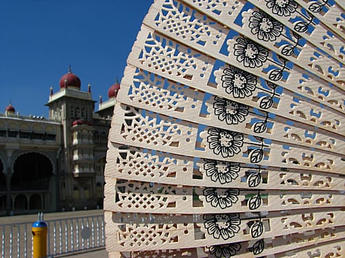 Mysore is famous for which things? A sandalwood fan, with the Mysore Palace in the background Image courtesy Hrishikesh Premkumar via Flickr